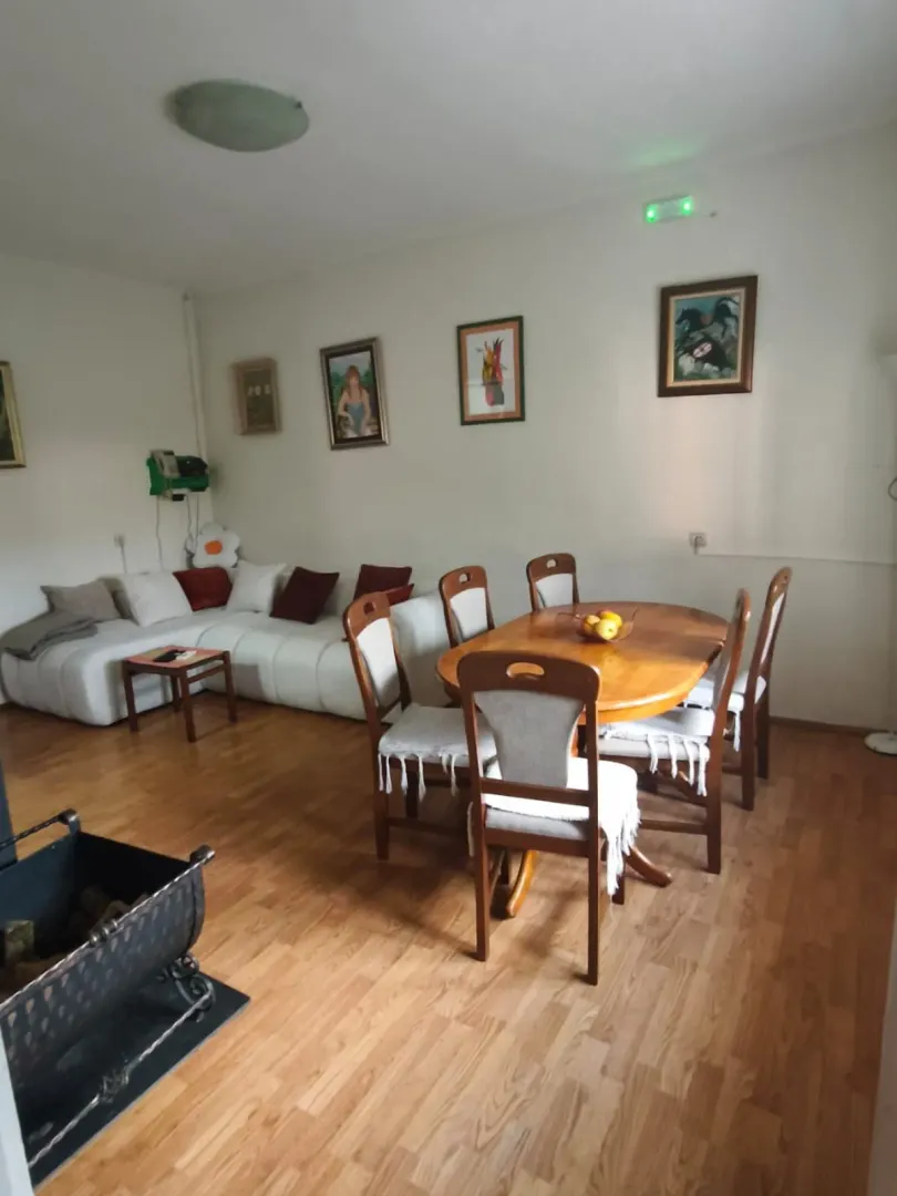 Living room with a dining table and sofa set.