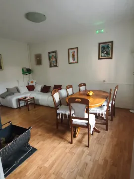 Living room with a dining table and sofa set. - image 2
