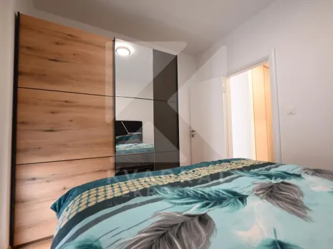 Bedroom with a large mirrored wardrobe and a double bed. - image 8