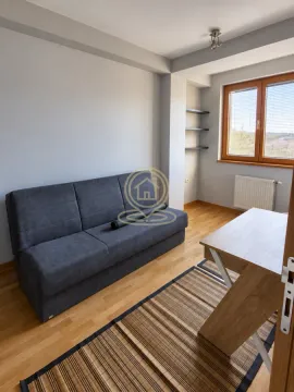 Living room with a grey sofa, desk and window. - image 12