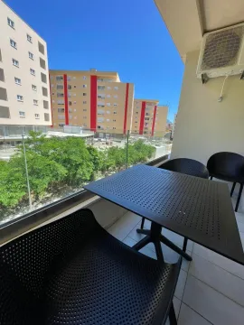 Furnished balcony with seating set and neighborhood view. - image 6
