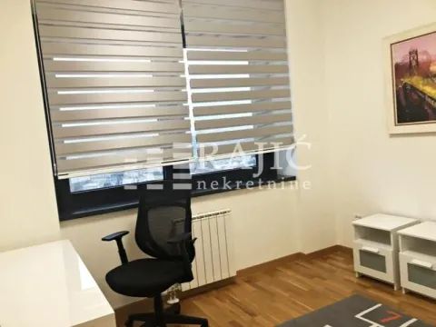 Furnished bedroom with a desk and window. - image 10