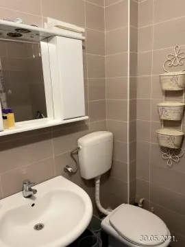 Small bathroom with a sink, toilet, and mirrored cabinet. - image 7