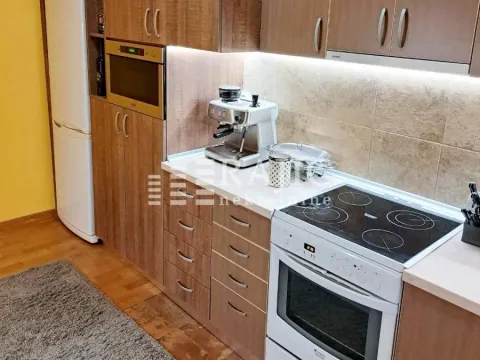 Modern kitchen with wooden cabinetry, white appliances, and a coffee machine. - image 16