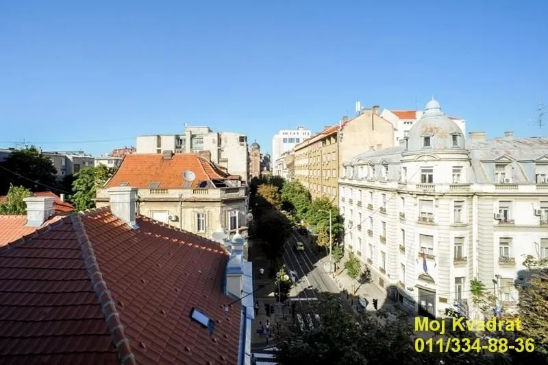 View from the window of the city street and surrounding buildings.