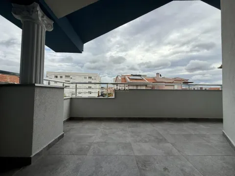 Spacious covered terrace with a view of the neighborhood and surrounding buildings. - image 16