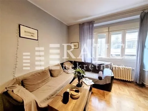 Living room with a sofa set and a wooden coffee table.