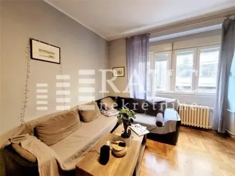 Living room with a sofa set and a wooden coffee table. - image 3