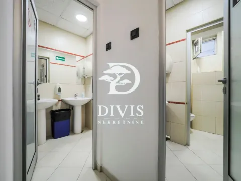 View of a tiled bathroom with sinks and toilets. - image 19