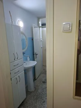 View of the bathroom with a washbasin and a white cabinet. - image 6