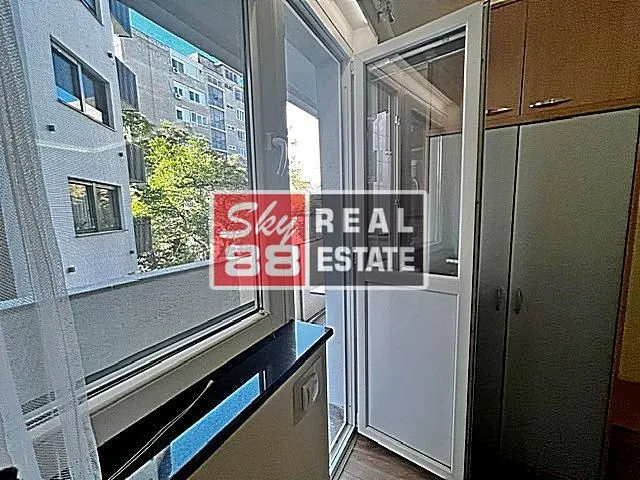 View through the balcony door toward the terrace with a built-in wardrobe.