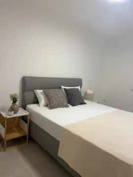 Furnished bedroom with a double bed and a nightstand. - image 2
