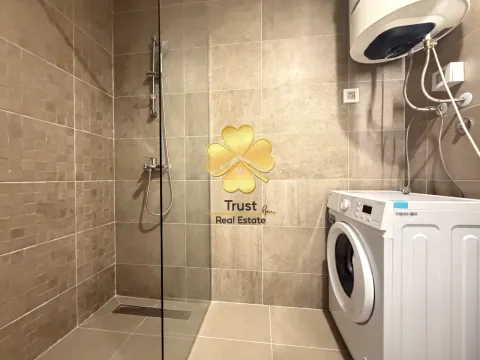 Modern bathroom with a shower cabin and a washing machine. - image 10