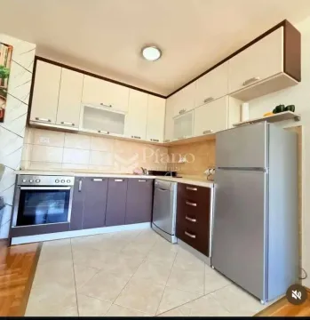 Kitchen with fitted units and a refrigerator. - image 3