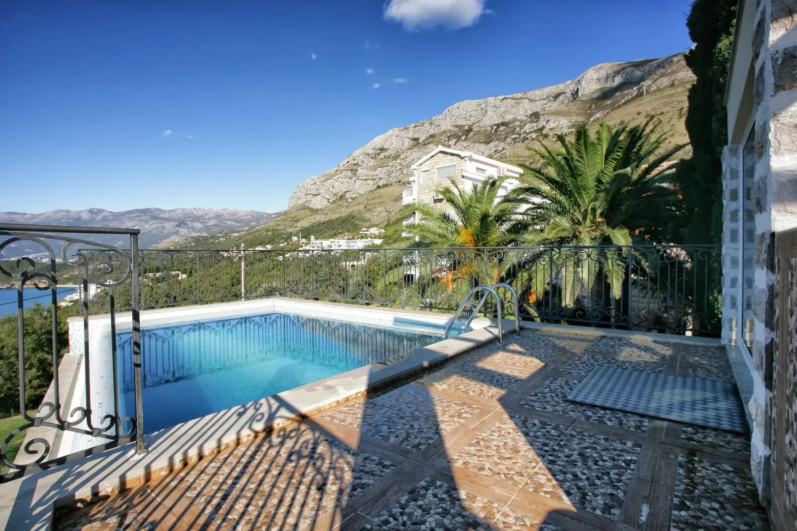 Terrace with a pool and mountain view.