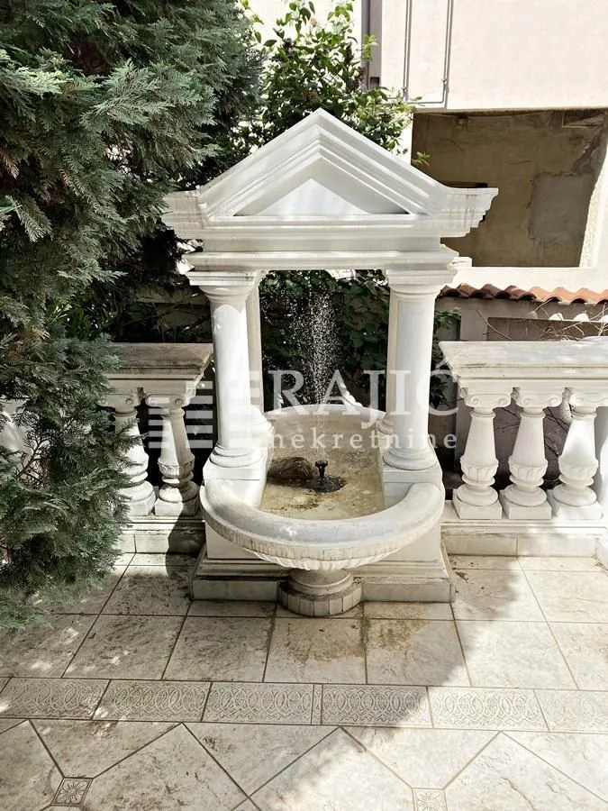 Decorative stone fountain in the courtyard with balustrades.