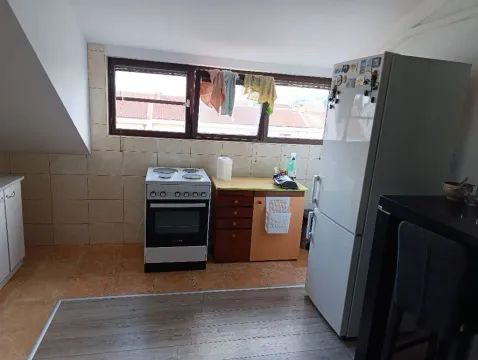 Kitchen equipped with a stove, refrigerator, and cabinetry. - image 3