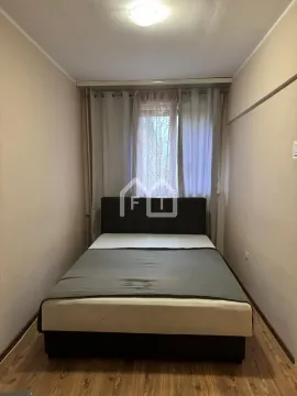 Smaller bedroom with a double bed and a window with curtains. - image 12