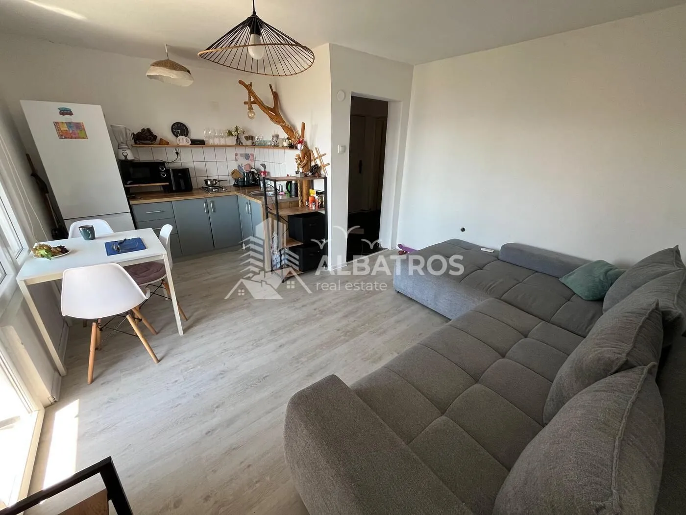 Open-plan living room with kitchen and dining area.