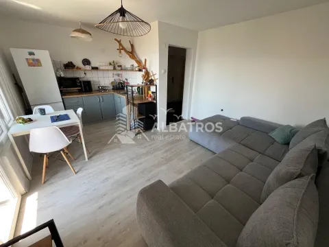 Open-plan living room with kitchen and dining area. - image 3