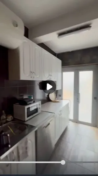 A simple kitchen with white cabinets.