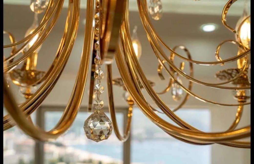 Close-up shot of a decorative gold chandelier with crystal pendants.