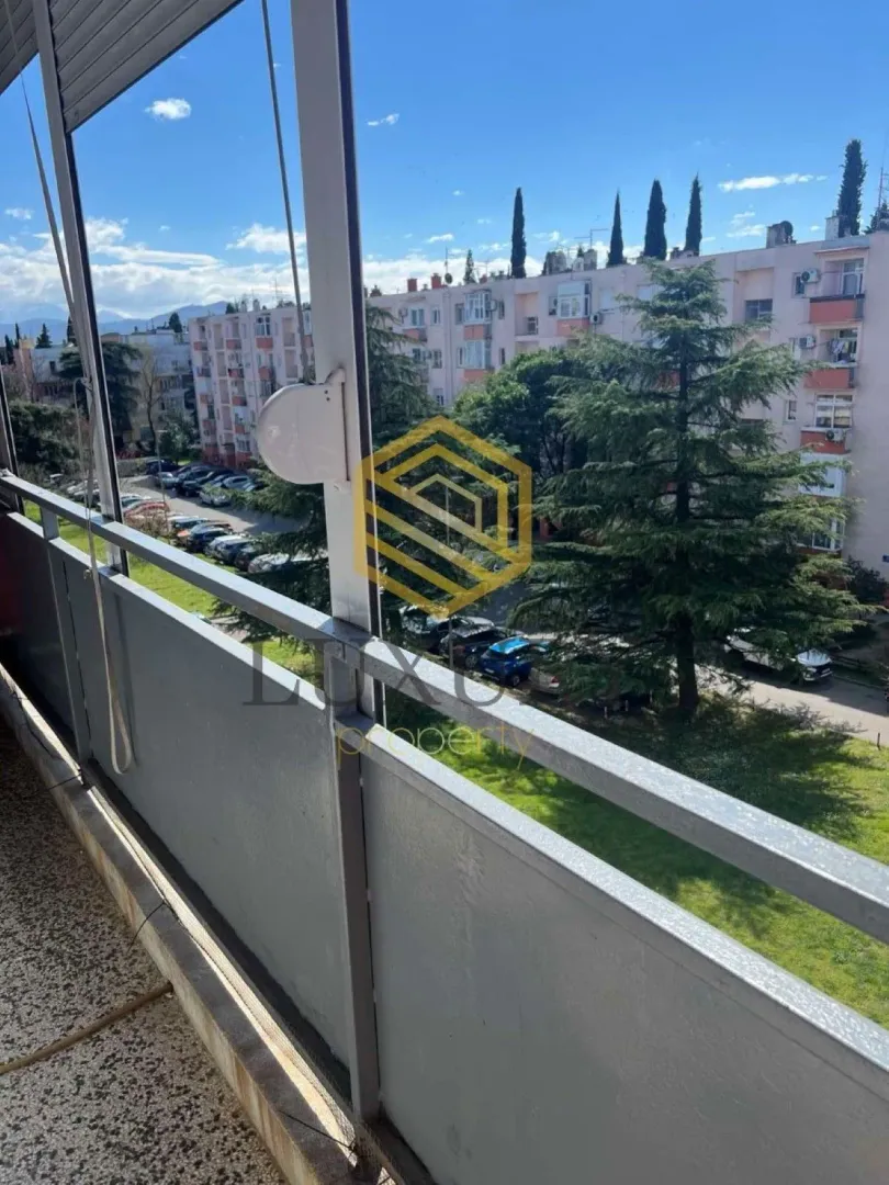 Pogled sa terase na okolne zgrade i zelenu površinu.