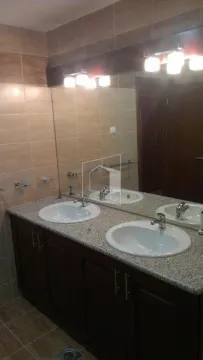 Bathroom with double sink and large mirror. - image 7