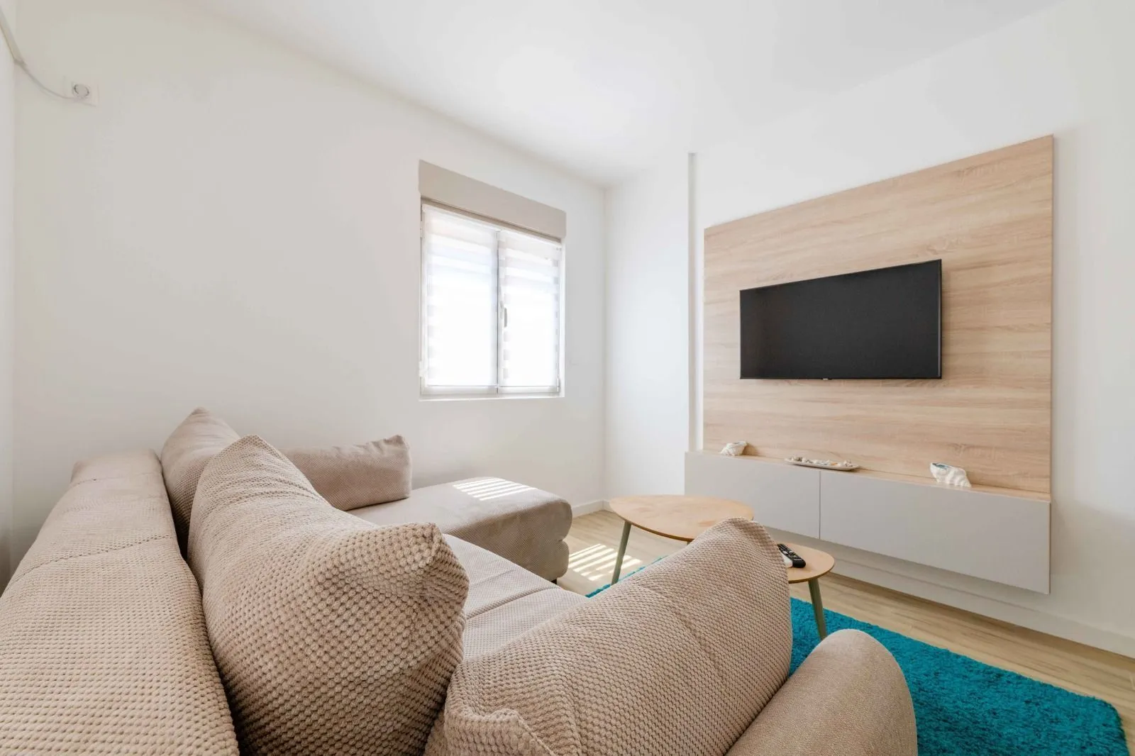 Living room with a sofa, TV, and a window.