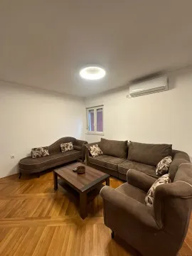 Living room with a seating set and a wooden coffee table. - image 2