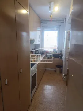 Small kitchen with wooden cabinetry and a window. - image 5