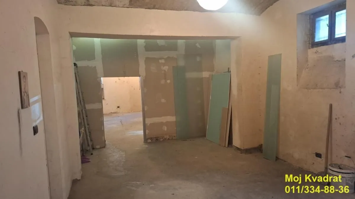 Empty room during renovation with drywall panels on the walls.