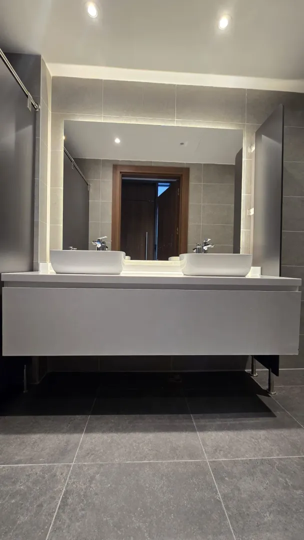 Modern bathroom with a double sink and a large mirror.