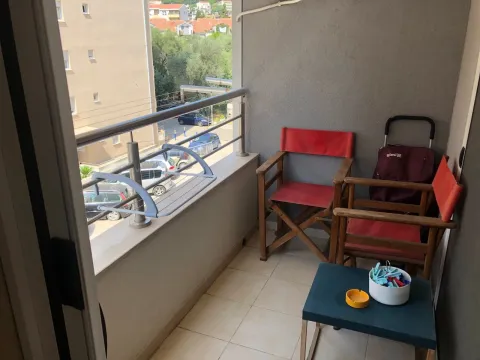 Smaller furnished balcony with chairs and a view of the street and buildings. - image 16