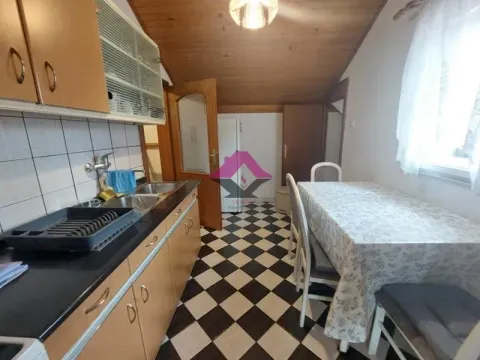 Kuhinja sa trpezarijskim stolom i drvenim elementima. - image 12