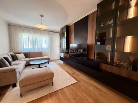 Living room with a sectional sofa, TV, and modern wooden wall panels. - image 6