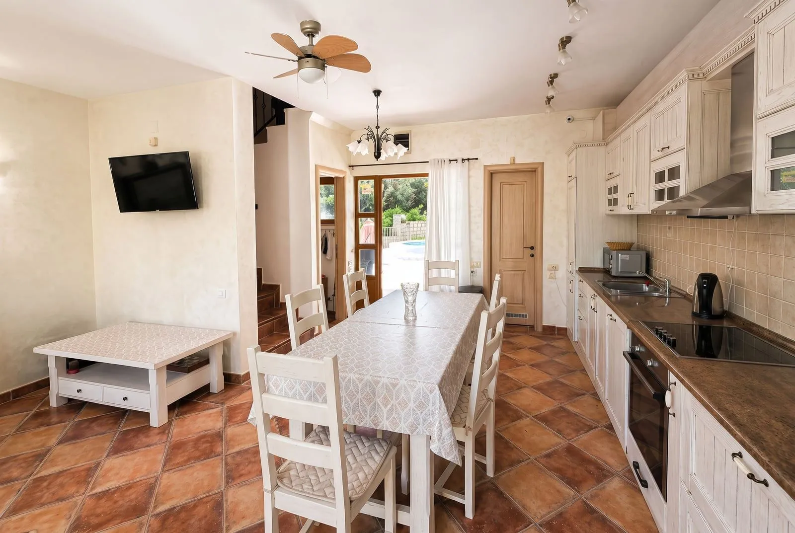 Spacious kitchen with dining area and exit to the yard.