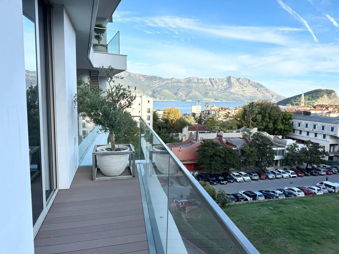 Modern balcony with wooden flooring and sea view.