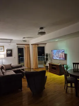 Spacious living room with sofa, TV and dining table. - image 14