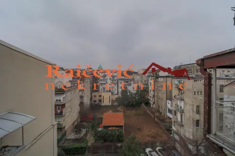 View from the terrace overlooking city buildings and a courtyard. - image 6
