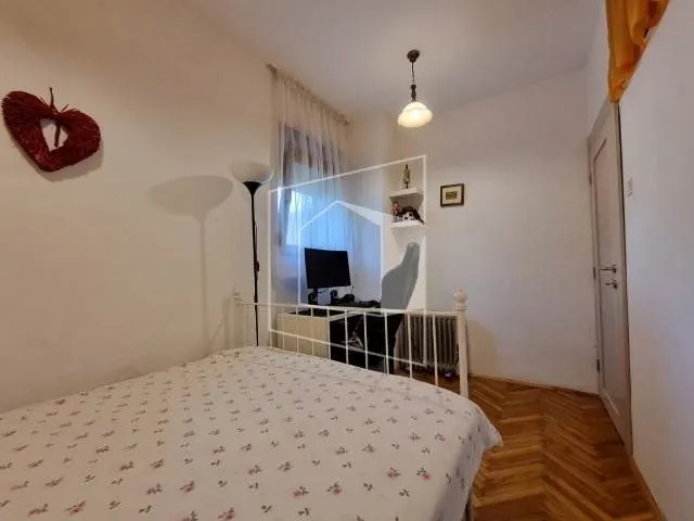 Smaller bedroom with a double bed and a desk.