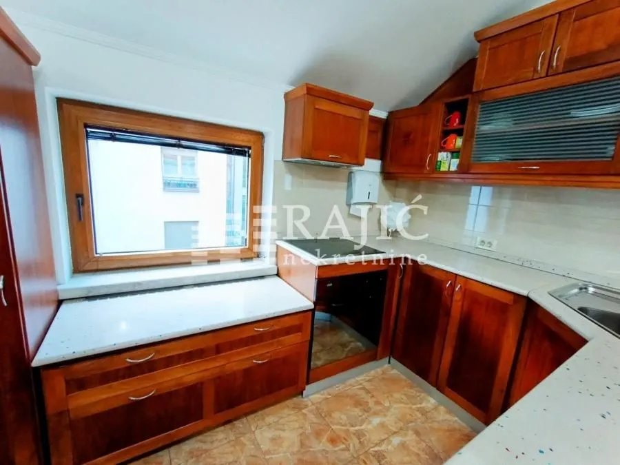 Small kitchen with wooden elements and countertops.