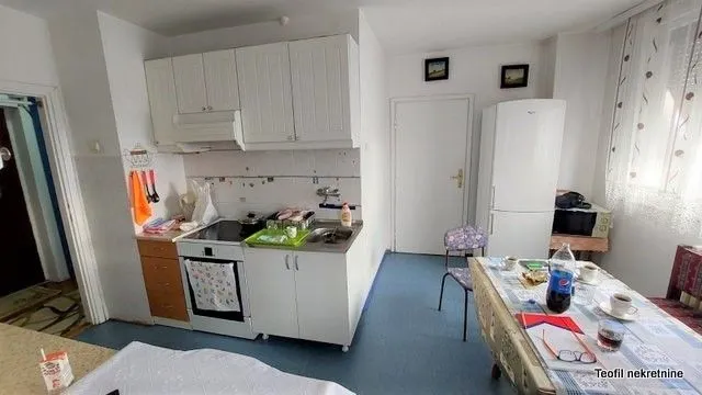 Kitchen with dining area and white cabinets.