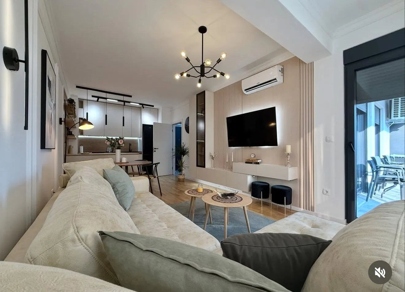 Modern and bright living room connected to the dining area and kitchen.