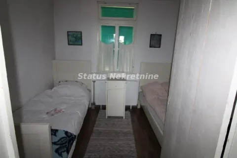 Bedroom with two beds and a window. - image 7