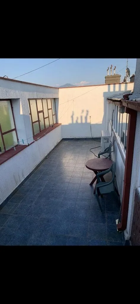 Spacious terrace with ceramic tiles and outdoor seating.
