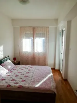 Bedroom with a double bed, window, and access to the terrace. - image 6