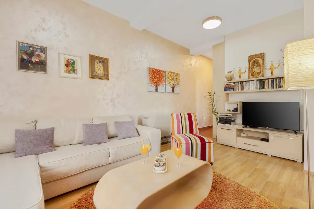 Living room with a sofa, TV unit, and coffee table.