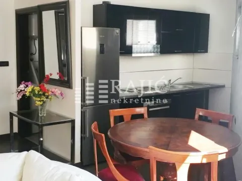 Kitchen with a dining table and black cabinetry. - image 6
