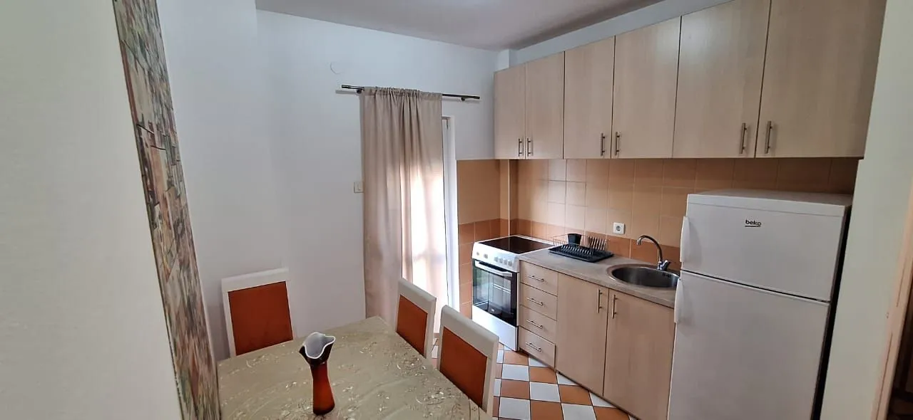 Small kitchen with a dining table and basic kitchen units.